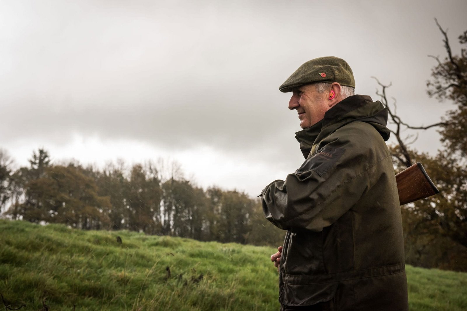 Gentleman walking with shotgun during a shoot organised by Lady's Wood Shooting School