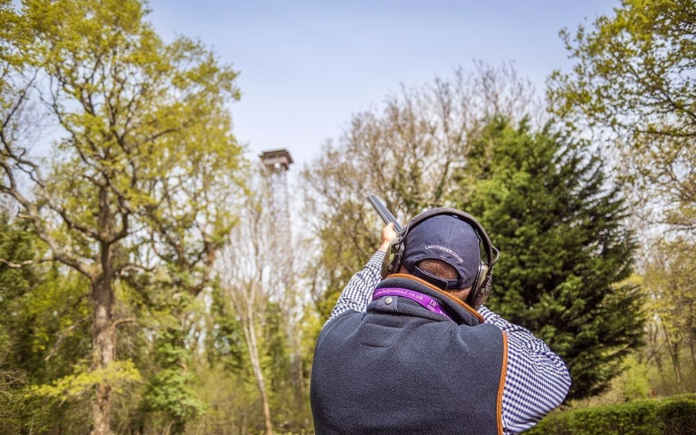 Clay pigeon shooting at Lady's Wood Shooting School in front of tower