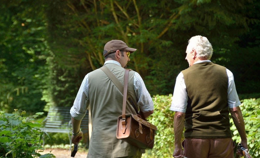 Instructor and client walking to a shoot at Lady's Wood Shooting School