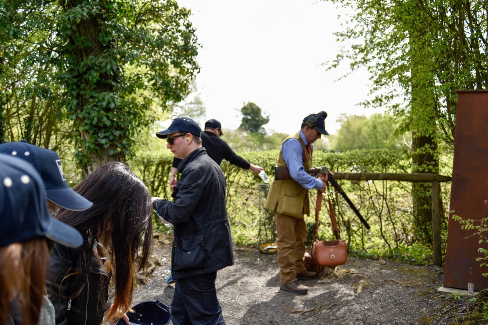 A group getting ready for clay pigeon shooting instruction at Cartridges ejecting while clay pigeon shooting at Lady's Wood Shooting School