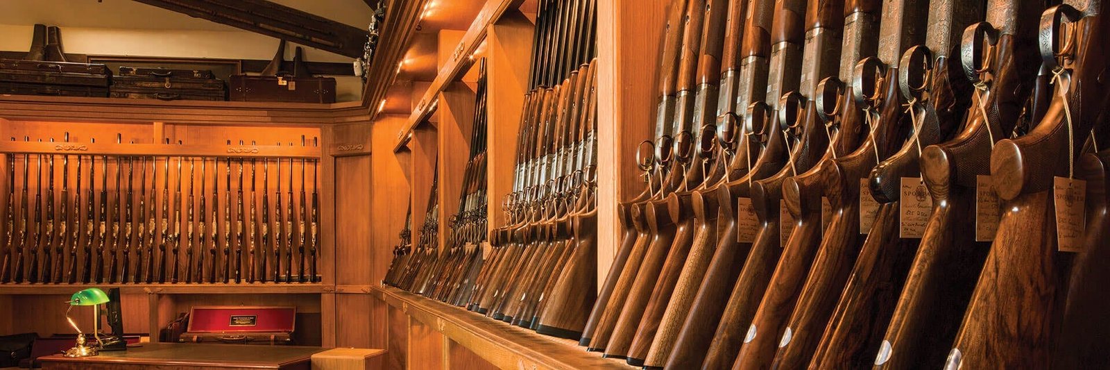 A gun rack filled with shotguns in the Sportarm at Lady's Wood Gun Room