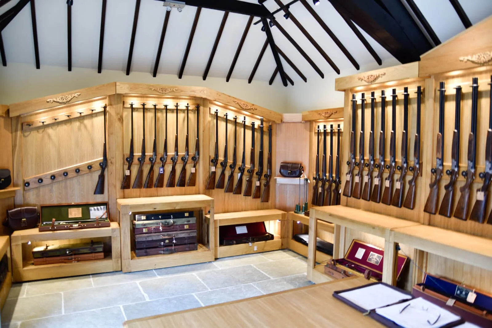 Gun racks full of shotguns at the Sportarm at Lady's Wood Gun Room