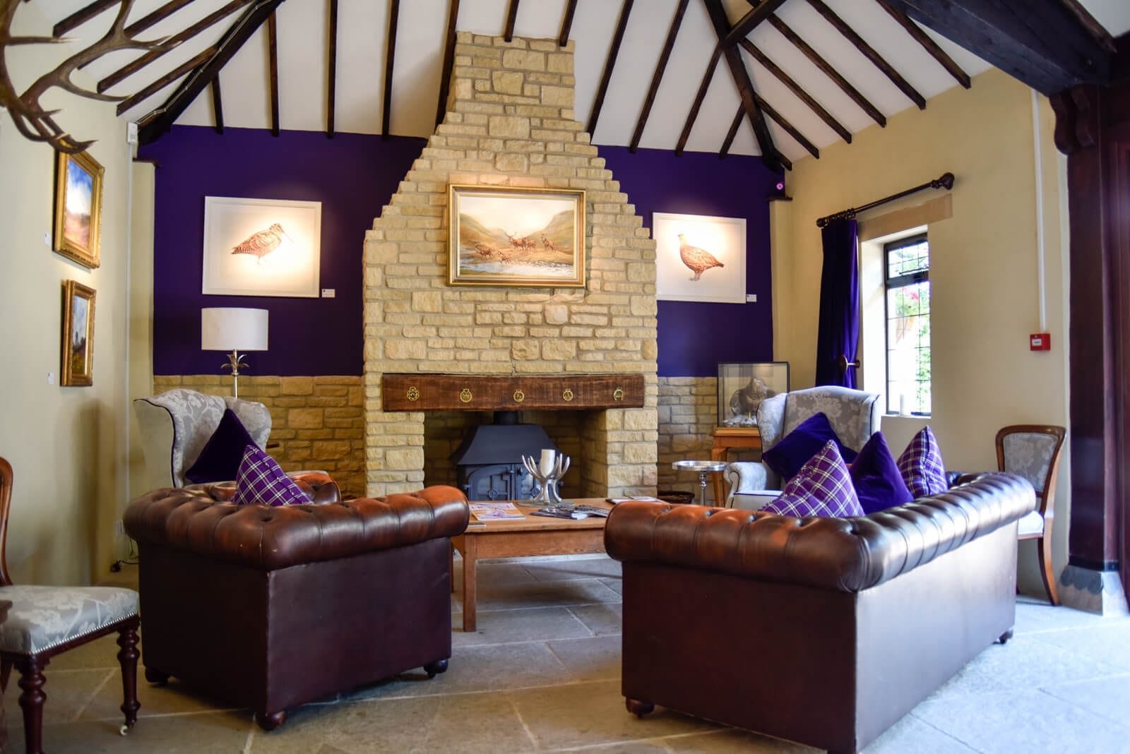 The fire and sofas in the meeting room at Lady's Wood Shooting School