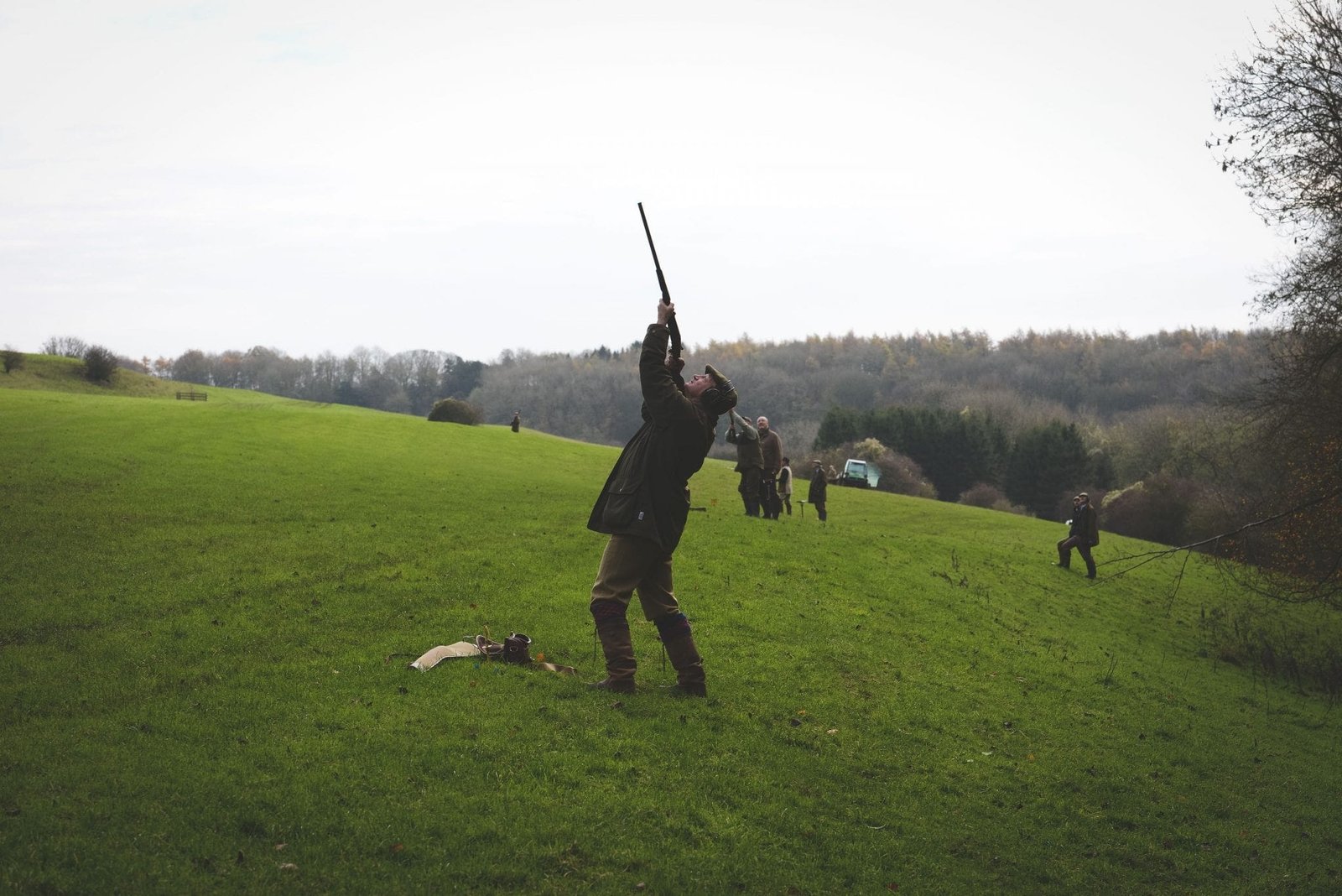 A gun aims at bird during a game shooting drive