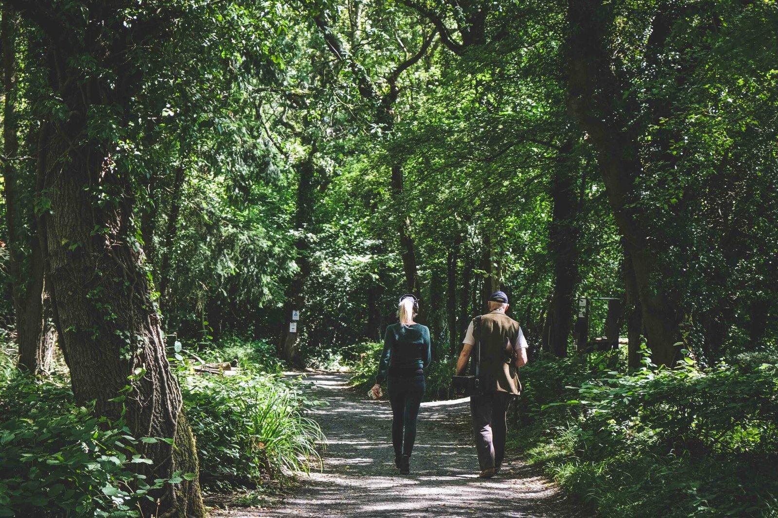 Customer and instructor walking through the grounds for a caddied practice at Lady's Wood